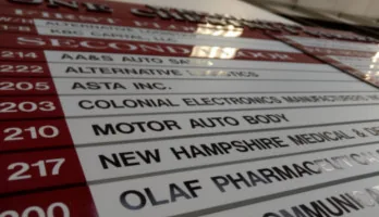 The building directory, with Motor Auto Body in suite 210